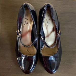 Black heels with strap over top of heel. Size 8